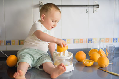 Portrait of cute baby boy playing with toy at home