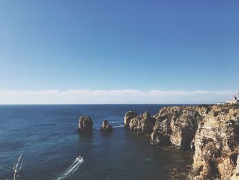 Scenic view of sea against clear blue sky