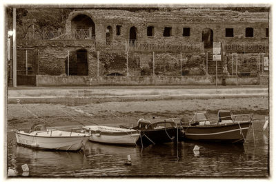 Boats in canal along buildings