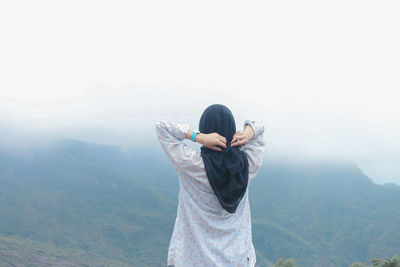 Rear view of woman looking at mountains