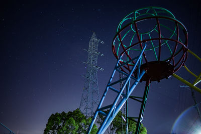 Low angle view of illuminated ferris wheel against sky at night