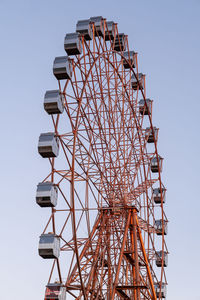 Low angle view of electricity pylon against clear sky