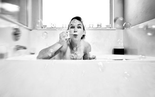 Portrait of young woman in bathroom