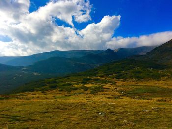 Scenic view of landscape against cloudy sky