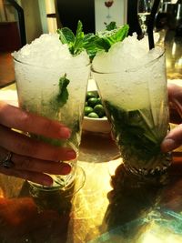 Cropped image of hand holding beer glass