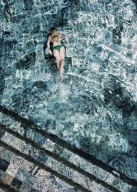 High angle view of woman swimming in pool