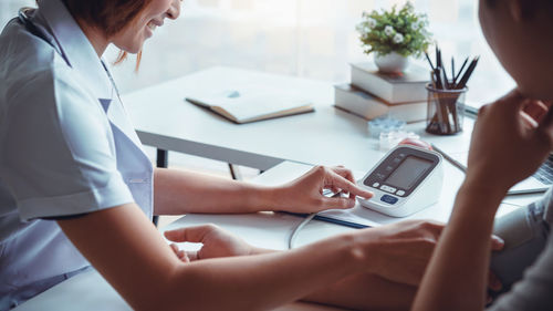 Midsection of woman using mobile phone