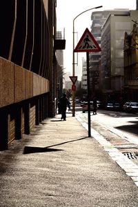 Empty road along built structures