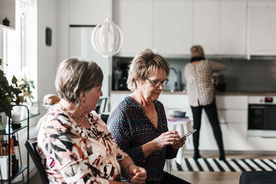 Women sitting on mobile phone