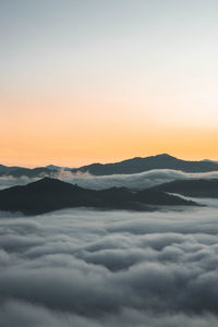 Scenic view of mountains against clear sky during sunset