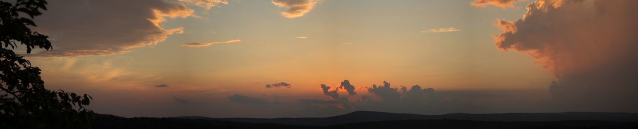 Scenic view of silhouette mountains against sky at sunset