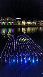 Reflection of illuminated lights in puddle