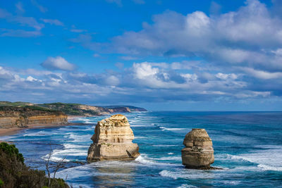Rock formation in sea against sky