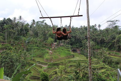 Rear view of two people in the forest