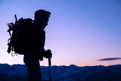 Young woman standing on summit of mountain during sunrise in montana