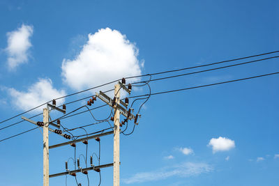 Low angle view of electricity pylon against sky