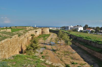 Scenic view of town against cloudy sky