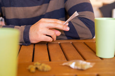 Midsection of woman using mobile phone