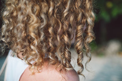 Close-up of woman with curly hair