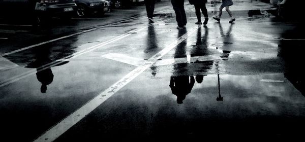 People walking in puddle