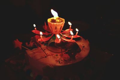 High angle view of illuminated candle