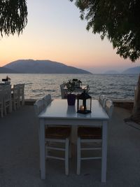 Scenic view of restaurant at beach against sky during sunset