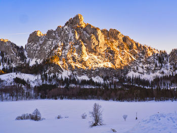 Scenic view of snow covered mountains against sky