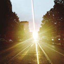 Road amidst trees against sky in city