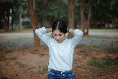 Smiling young woman standing outdoors