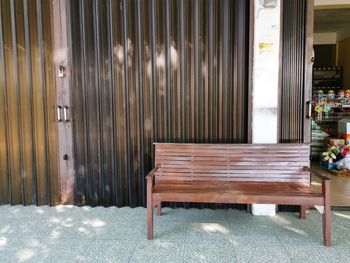 Empty bench by building at home