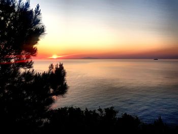 Scenic view of sea against romantic sky at sunset