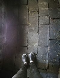 Low section of man standing on floor