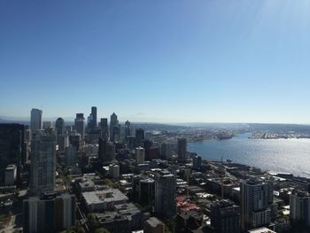 Aerial view of buildings in city against clear sky