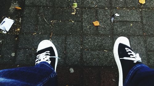 Low section of person standing on road