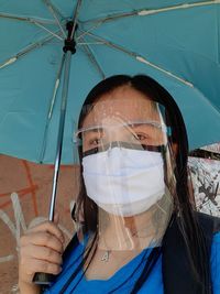 Portrait of woman holding umbrella