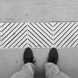 Low section of man standing on street