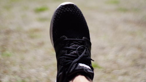 Low section of person wearing canvas shoes