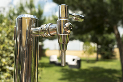 Close-up of faucet on field