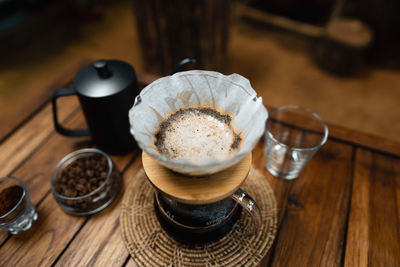 High angle view of coffee and cups on table