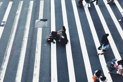 High angle view of people crossing road