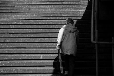 Rear view of person moving on steps