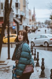 Woman standing on street in city during winter