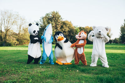 People wearing costume standing at park outdoors