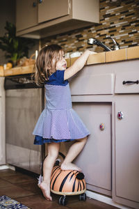 Girl standing by kitchen counter