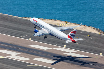 High angle view of airplane flying over sea