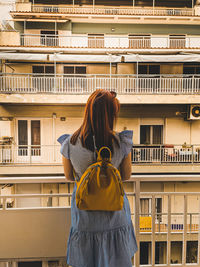 Rear view of a woman on the balcony