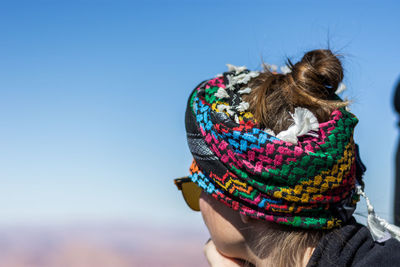 Rear view of woman against blue sky