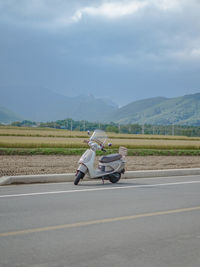 Motorcycle on road against sky