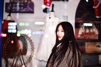 Portrait of young woman standing in store