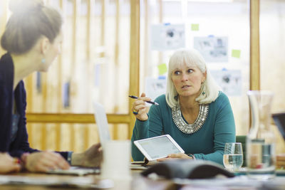 Businesswomen discussing in board room at office